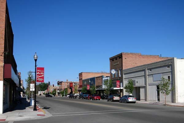 Historic downtown Emmett Idaho showing Main Street with brick buildings and Welcome to Emmett banner on lamp post