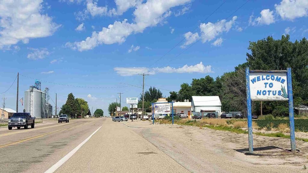 Welcome to Notus Idaho sign along main street with grain silos and rural downtown